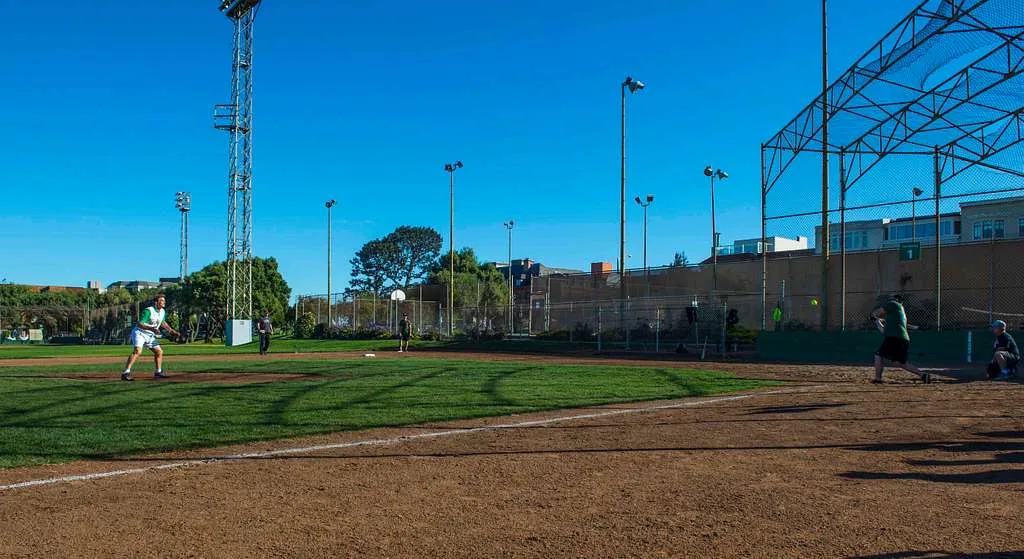 Softball game in progress at a park in Alameda, California
